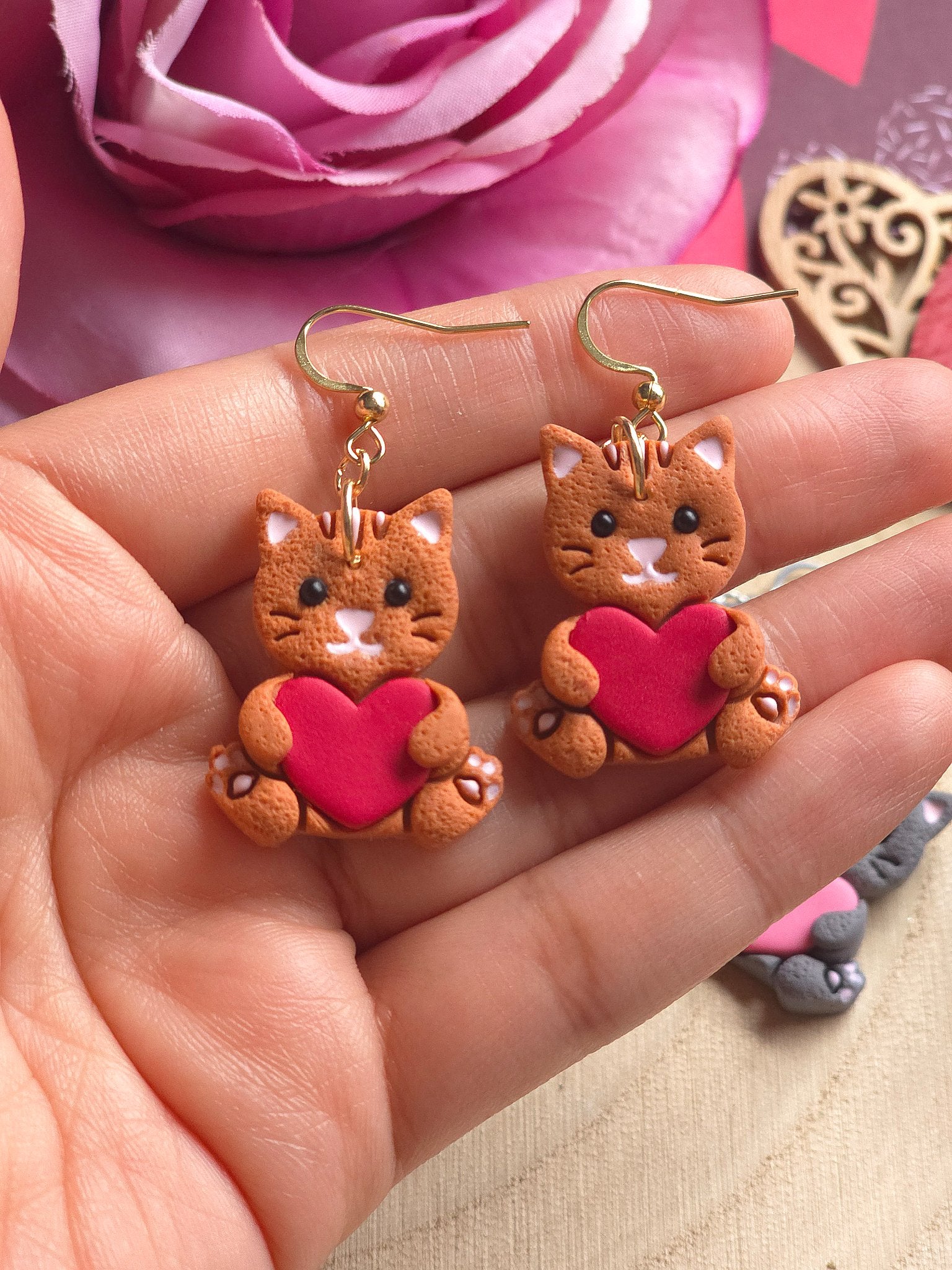 67b9ea7598f8a707689a5b69_catsholdingheart-orange_1770361366476.jpg