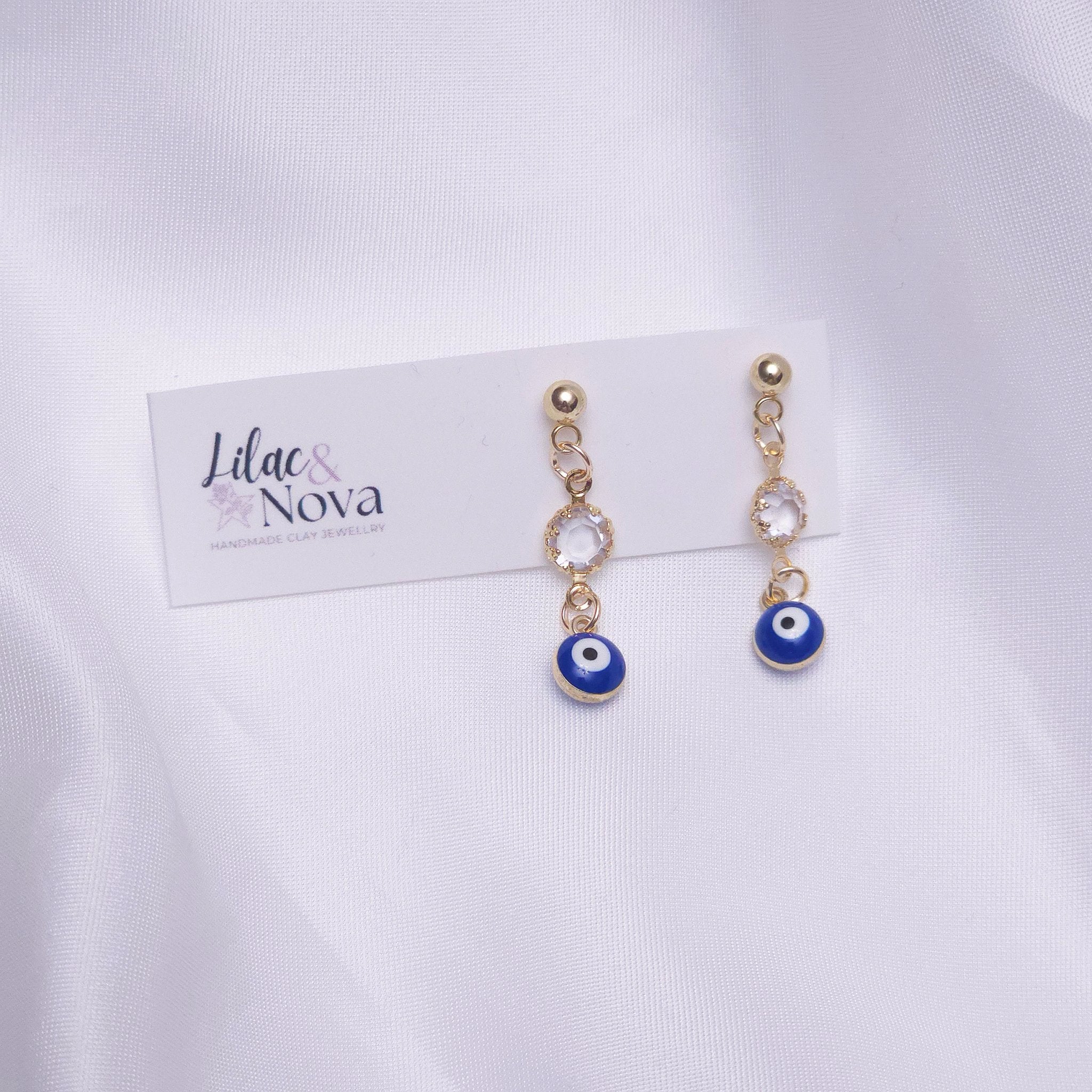 67b9ea7598f8a707689a5b69_goldevileyegemdropearring_1778730940093.jpg