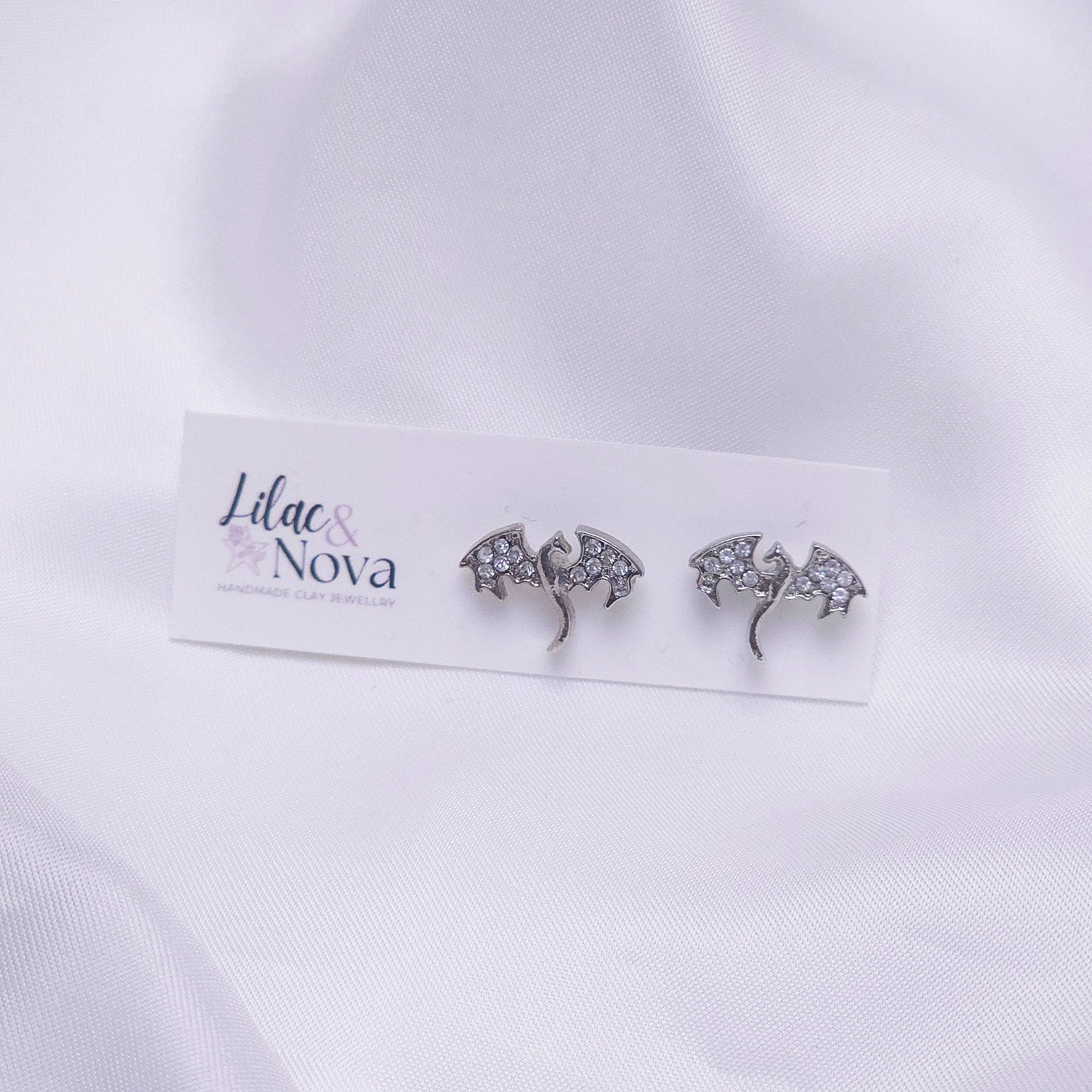 67b9ea7598f8a707689a5b69_rhinestonedragonsilverstudearring_1778730811374.jpg